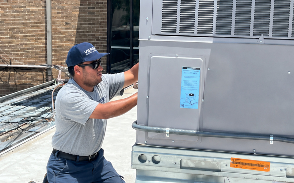 Man In Versa Hat Working On Hvac