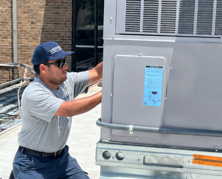 Man In Versa Hat Working On Hvac