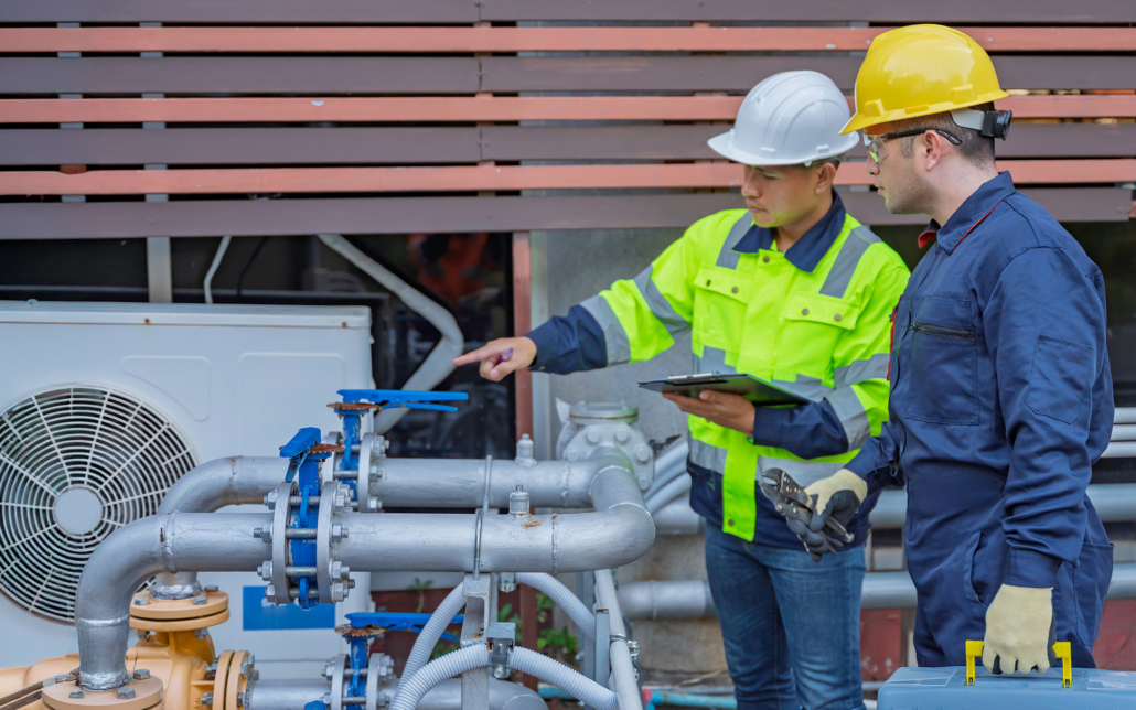 Two Workers Look At Hvac