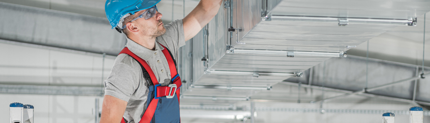 Worker Inspecting Ductowrk For Hvac